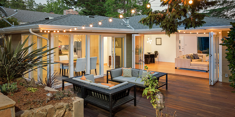 Cozy backyard with wooden deck and open sliders